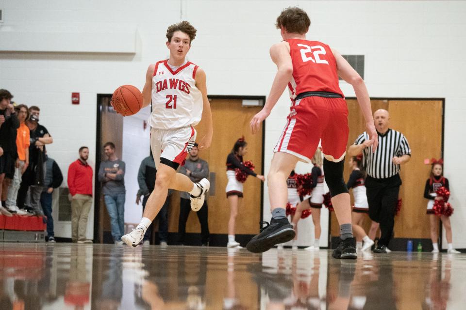 Rossville freshman Jack Donovan (21) dribbles down court during the first half of Tuesday's game against Osage City.