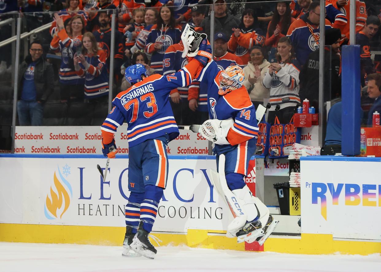 Two Oilers celebrate after beating the Predators on Jan. 27. (Lawrence Scott/Getty Images)