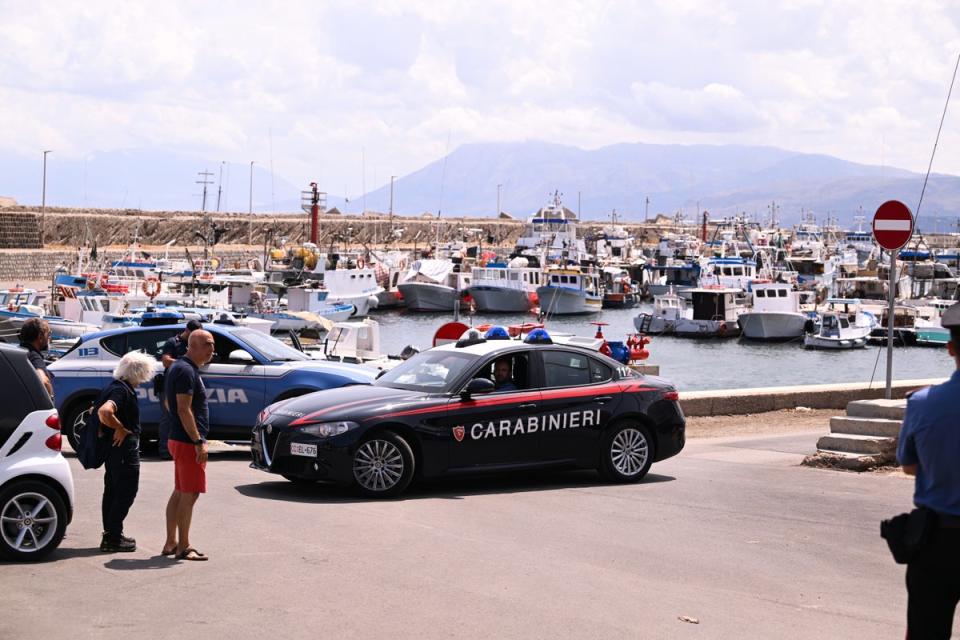 Police cars at the scene as the search continues for the missing tourists (Getty)