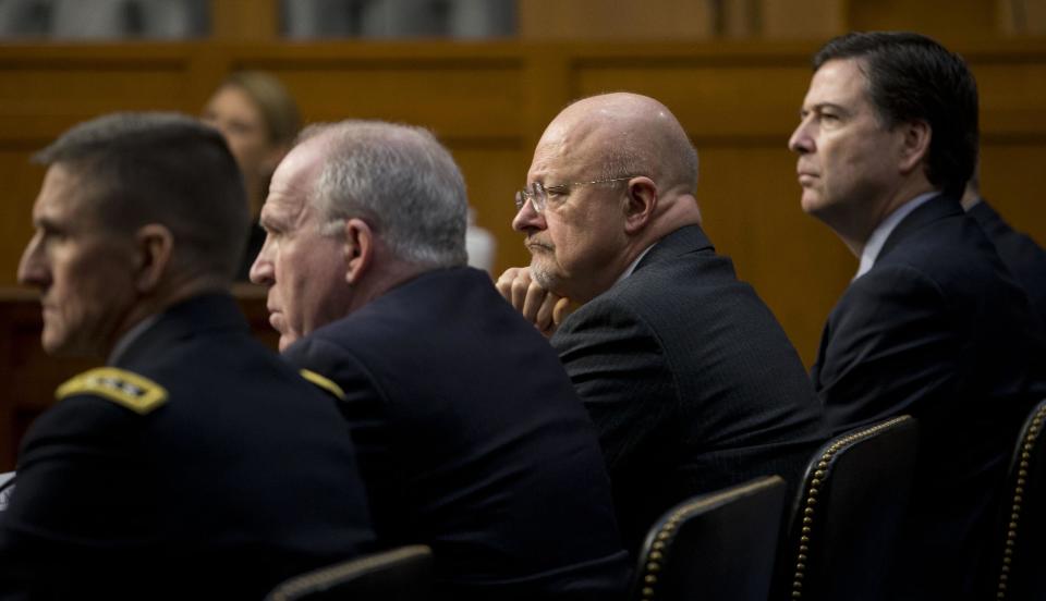 Director of National Intelligence James Clapper, second from right, listens on Capitol Hill in Washington, Wednesday, Jan. 29, 2014, while testifying before the Senate Intelligence Committee hearing on current and projected national security threats against the US. From left are, Defense Intelligence Agency Director Lt. Gen. Michael Flynn, CIA Director John Brennan, Clapper and FBI Director James Comey. (AP Photo/Pablo Martinez Monsivais)