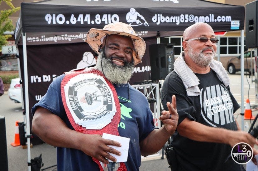 Grand champion Michael “Shot Gun” Collins and organizer Bruce Yeomans at Fayetteville's first Black BBQ Cook-Off, Aug. 21, 2022 at Murchison Marketplace.