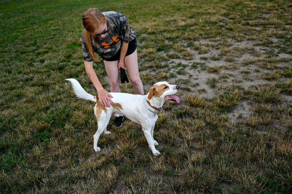 Morgan Miller pets her dog Riggin on Wednesday, July 13, 2022, at the Northern Tail Dog Park in East Lansing.