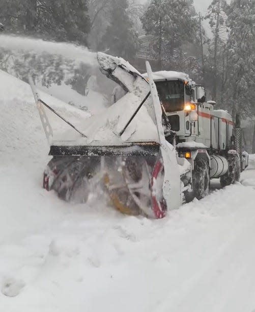 A Caltrans snow blower clears a mountain roadway after a recent snow storm in the San Bernardino Mountains.