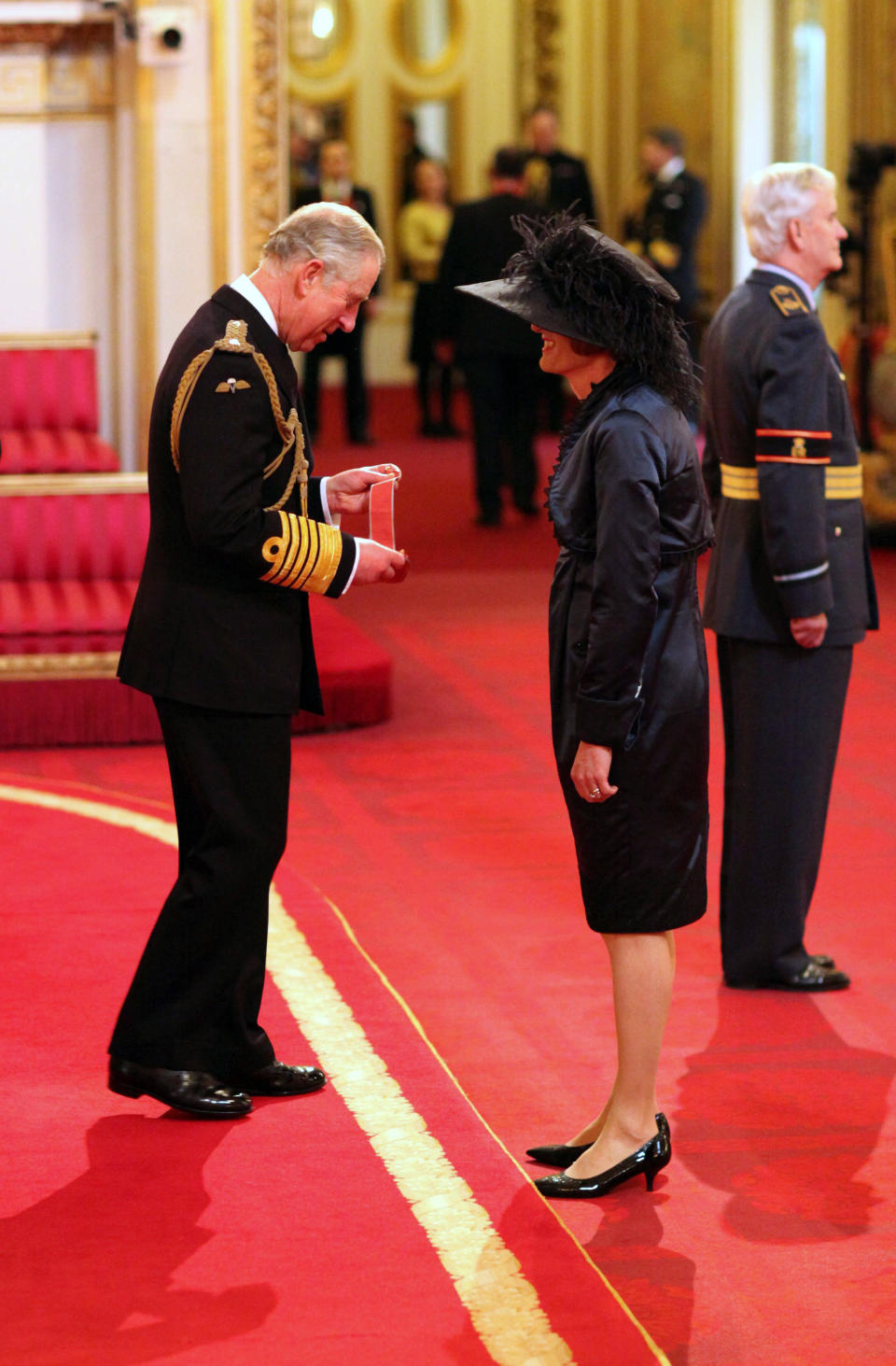 Artist Grayson Perry, right, is awarded a CBE (Commander of the Most Excellent Order of the British Empire) by Britain's Prince Charles, the Prince of Wales, during an investiture ceremony at Buckingham Palace, in London, Friday, Jan. 24, 2014. (AP Photo / Jonathan Brady/PA) UNITED KINGDOM OUT