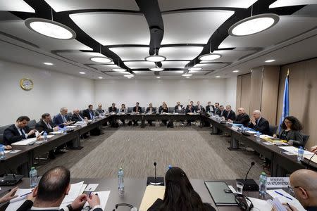 Syrian Ambassador to the United Nations (UN) and Head of the Government delegation Bashar al-Jaafari (3rd L) faces UN Special Envoy of the Secretary-General for Syria Staffan de Mistura (2nd R) at the opening of a new round of negotiations of peace talks on Syria at the United Nations Office in Geneva in this March 21, 2016 file photo. REUTERS/Fabrice Coffrini/Pool/Files