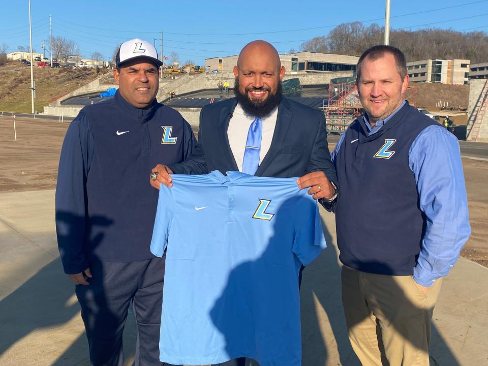 Brian Lilly, center, was named the first James Lawson football coach. To his left is athletic director Pete Froedden and to his right is principal Stephen Sheaffer.