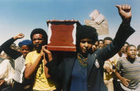 <p>Winnie Mandela, black activist and wife of jailed South African National Congress leader Nelson Mandela, carries the coffin of William Kotoyi at his funeral in Brandfort, South Africa, on April 5, 1986. In a speech there, she called for full sanctions against South Africa for its apartheid policies. (Photo: AP) </p>