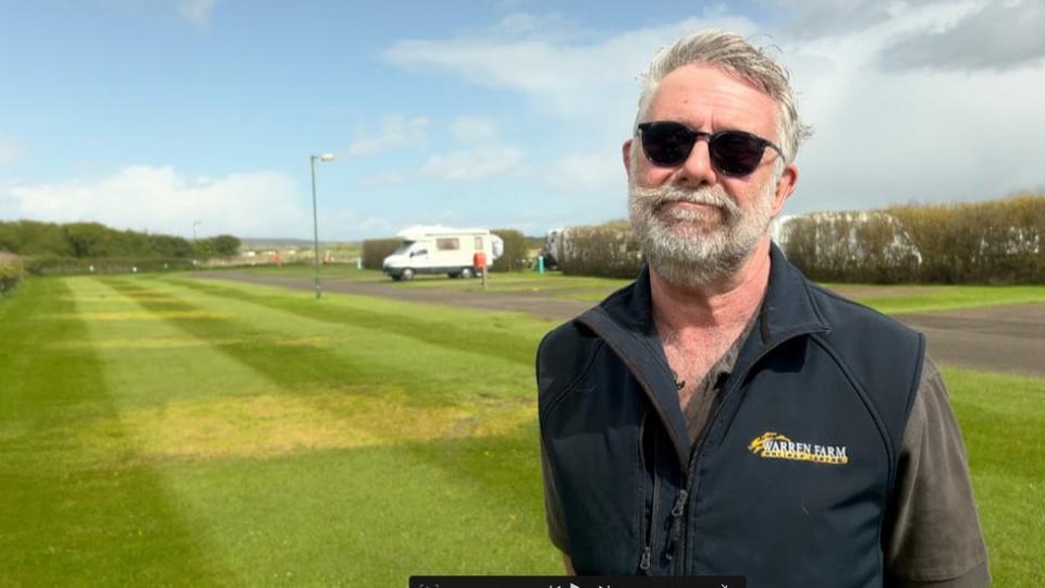 Paul Bowkett from Warren Farm Holiday Park standing in front of his pitches