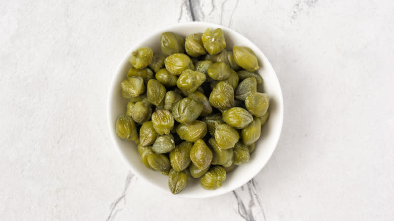 capers in a white bowl