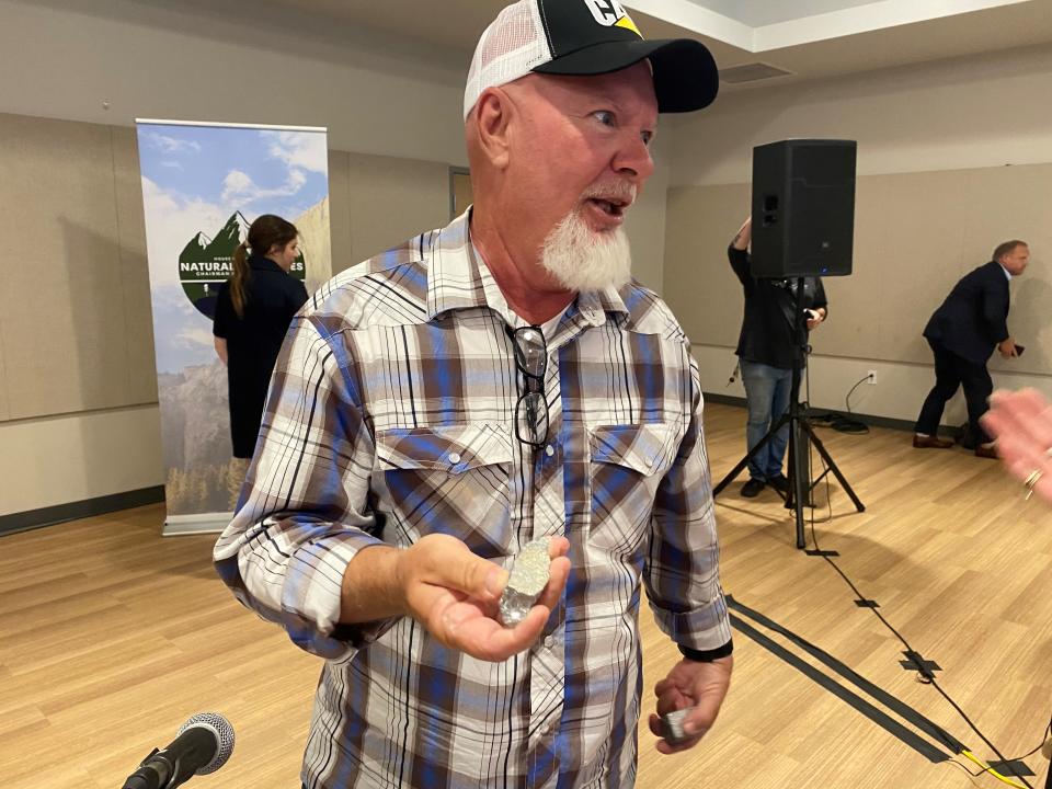 Craig Wiita, president and CEO of a refining firm, holds antimony he brought to a congressional field hearing in Goodyear on July 21, 2023.