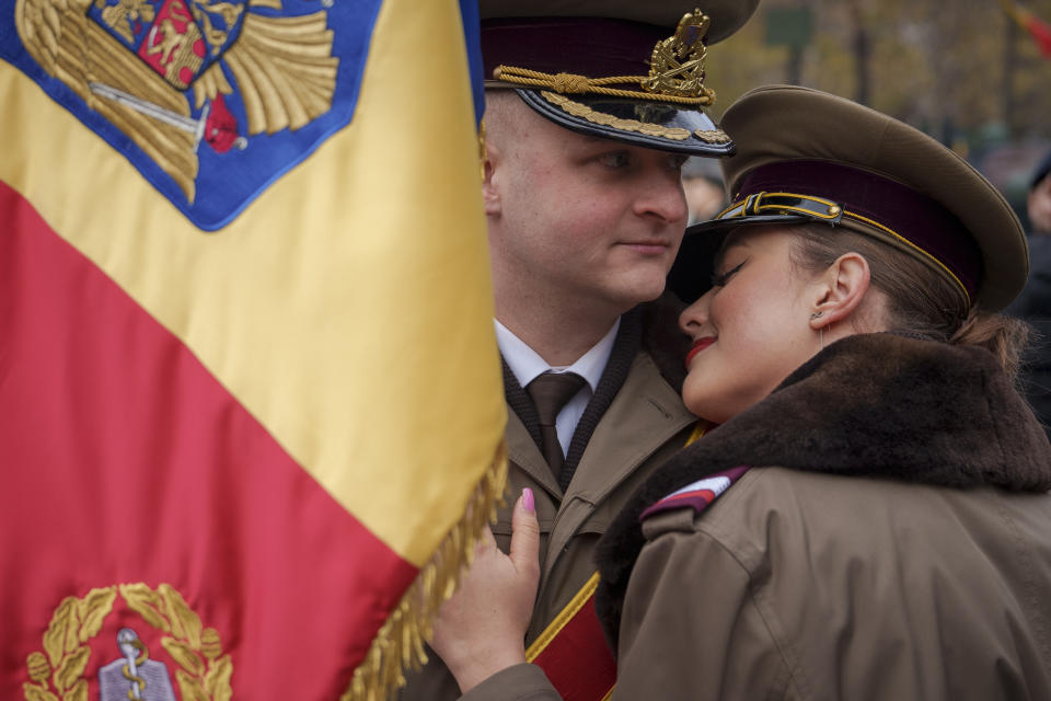 Military cadets hug before taking part in the National Day parade in Bucharest, Romania, Friday, Dec. 1, 2023. Tens of thousands of people turned out in Romania's capital on Friday to watch a military parade that included troops from NATO allies to mark the country's National Day. (AP Photo/Vadim Ghirda)