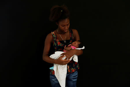 Edith Torres, 18, from Honduras poses for a photograph with her newborn baby at a migrant shelter, known as The 72, in Tenosique, Tabasco, Mexico, April 12, 2017. "I left Honduras for a better future whether it's in Mexico or in the United States. In Honduras it's very difficult," Torres said. REUTERS/Carlos Jasso