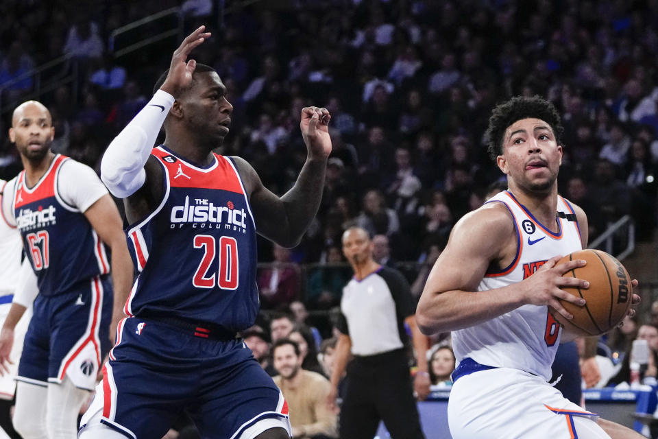 Washington Wizards' Kendrick Nunn (20) defends New York Knicks' Quentin Grimes during the first half of an NBA basketball game Sunday, April 2, 2023, in New York. (AP Photo/Frank Franklin II)