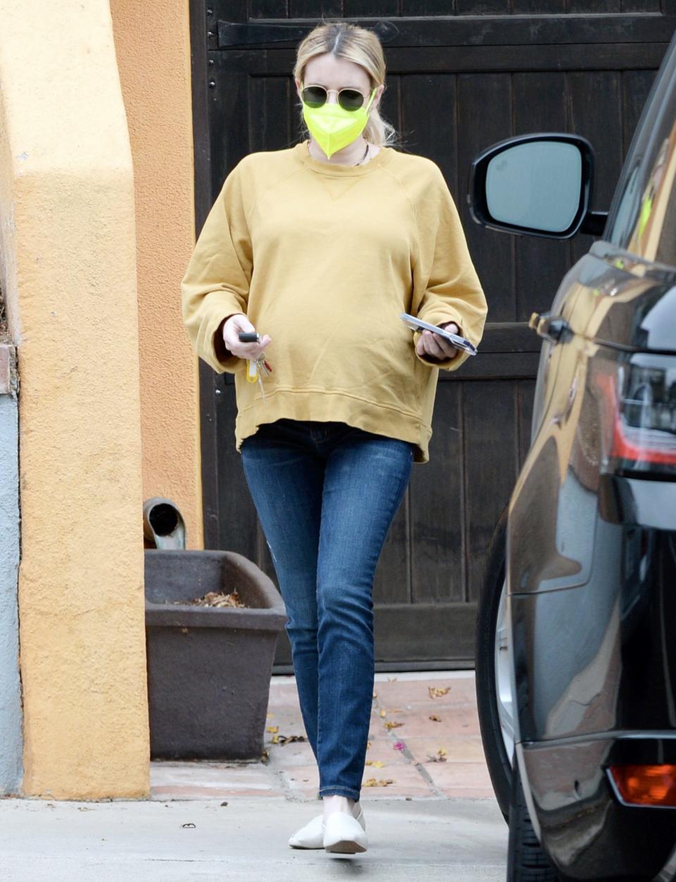 <p>Emma Roberts wore a yellow sweater, jeans and a neon yellow mask as she went about her day on Monday in L.A.</p>