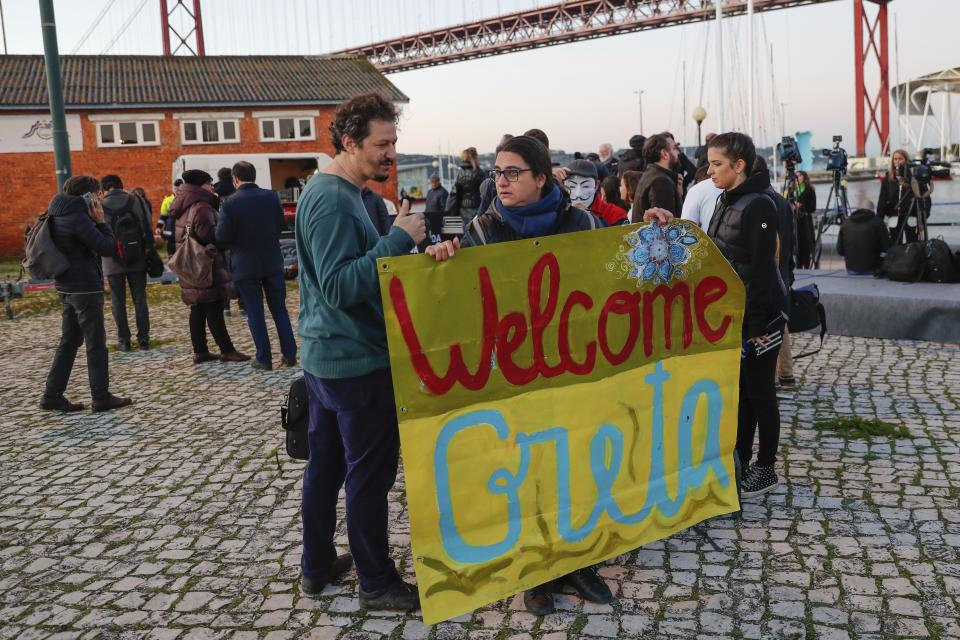 Climate activists wait for the arrival of Greta Thunberg in Lisbon, Tuesday, Dec 3, 2019. Climate activist Greta Thunberg has arrived by catamaran in the port of Lisbon after a three-week voyage across the Atlantic Ocean from the United States. The Swedish teen sailed to the Portuguese capital before heading to neighboring Spain to attend the U.N. Climate Change Conference taking place in Madrid (AP Photo/Armando Franca)