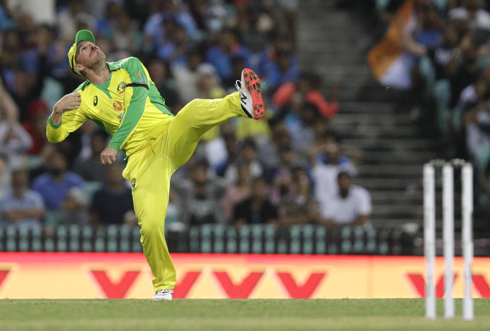 Australia's Aaron Finch celebrates after taking a catch to dismiss India's Virat Kohli during the one day international cricket match between India and Australia at the Sydney Cricket Ground in Sydney, Australia, Friday, Nov. 27, 2020. (AP Photo/Rick Rycroft)