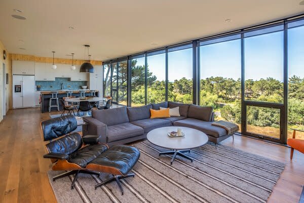 A free-flowing open layout awaits inside, where the main living areas capture ocean views.