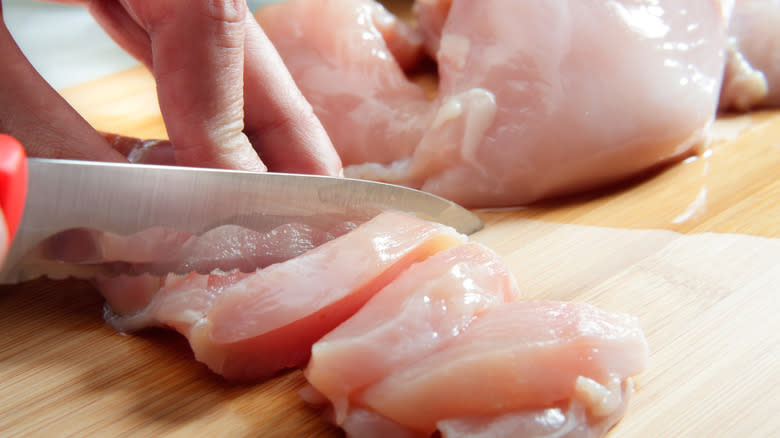 Cutting raw chicken breast