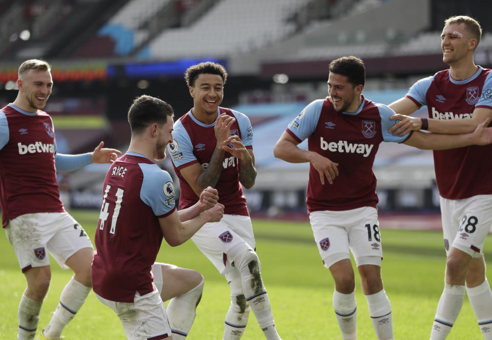 CORRECTS SPELLING OF NAME West Ham's Jesse Lingard, centre, celebrates with teammates after scoring his side's second goal during the English Premier League soccer match between West Ham United and Tottenham at the London Stadium in London, Sunday Feb. 21, 2021. (AP Photo/Kirsty Wigglesworth, Pool)