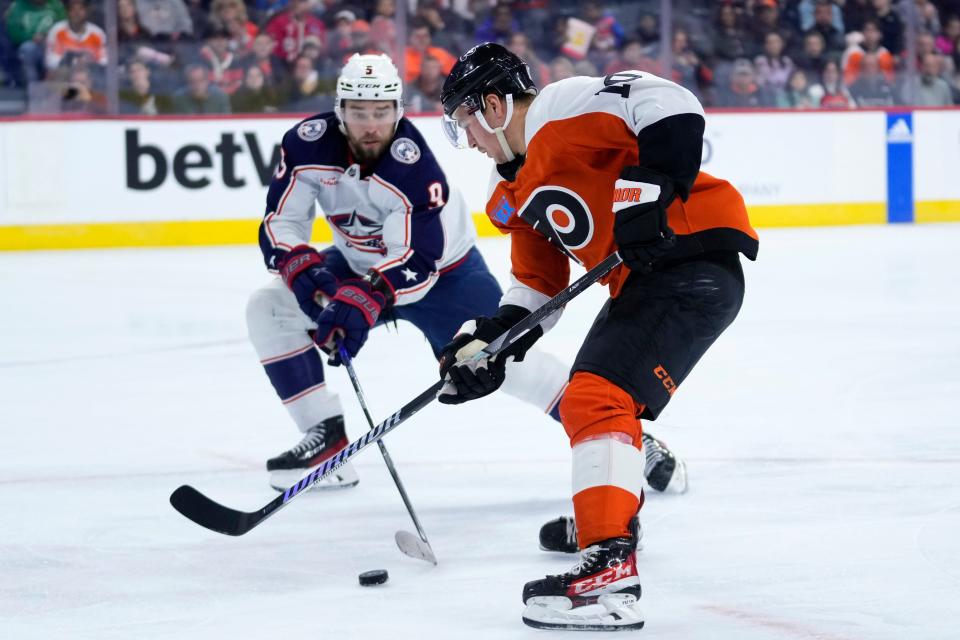 Philadelphia Flyers' Bobby Brink, right, and Columbus Blue Jackets' Ivan Provorov battle for the puck during the second period of an NHL hockey game, Sunday, Nov. 19, 2023, in Philadelphia. (AP Photo/Matt Slocum)