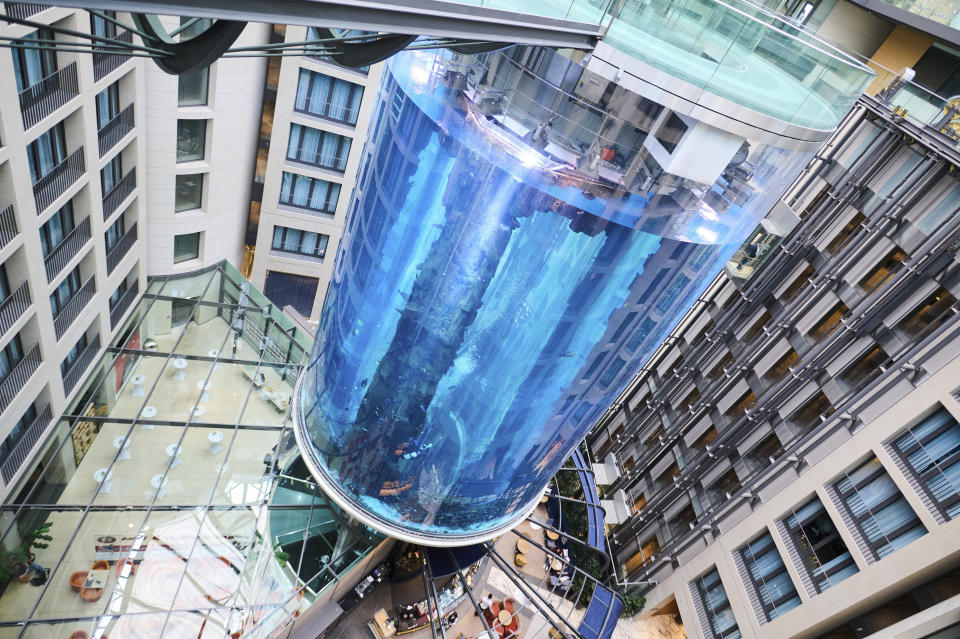 The AquaDom aquarium at the Sea Life tourist attraction photographed in Berlin, Wednesday, June 1, 2022. The aquarium is bursts on Friday, Dec. 16, 2022. Operators say the aquarium has the biggest cylindrical tank in the world. It contained 1,500 tropical fish before the incident. (Annette Riedl/dpa via AP)