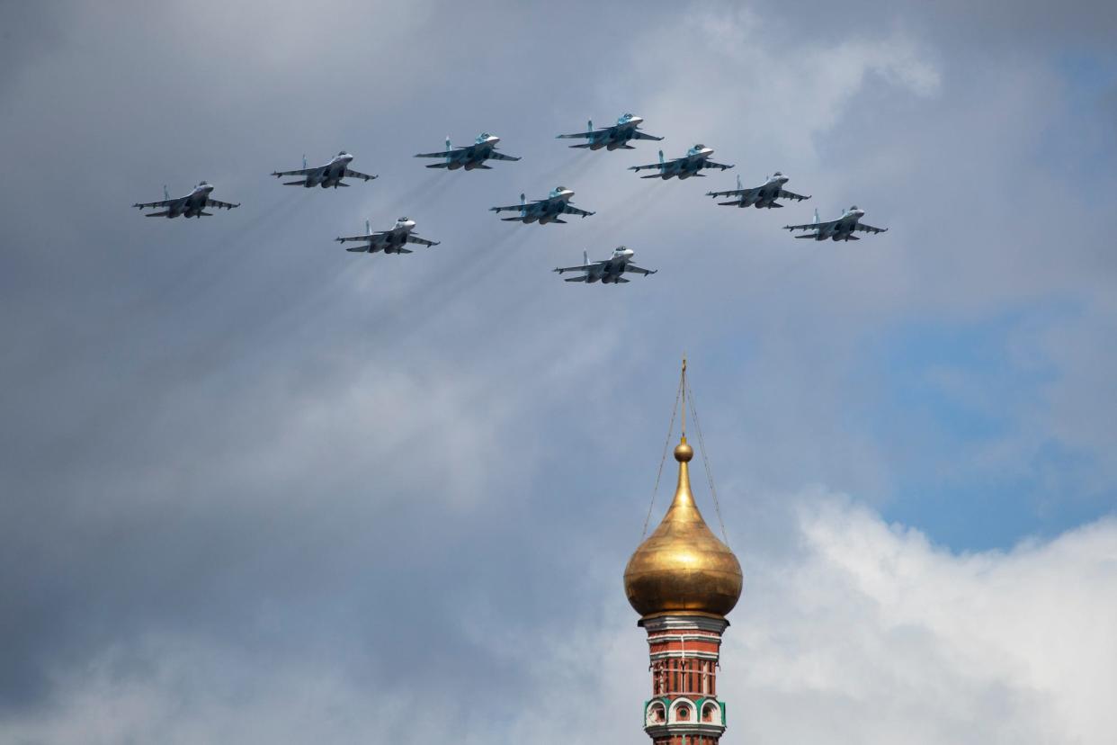 Russian Air Force Sukhoi fighter jets and bombers fly over St. Basil's Cathedral during a rehearsal for the Victory Day military parade in Moscow, Russia, Wednesday, May 5, 2021.