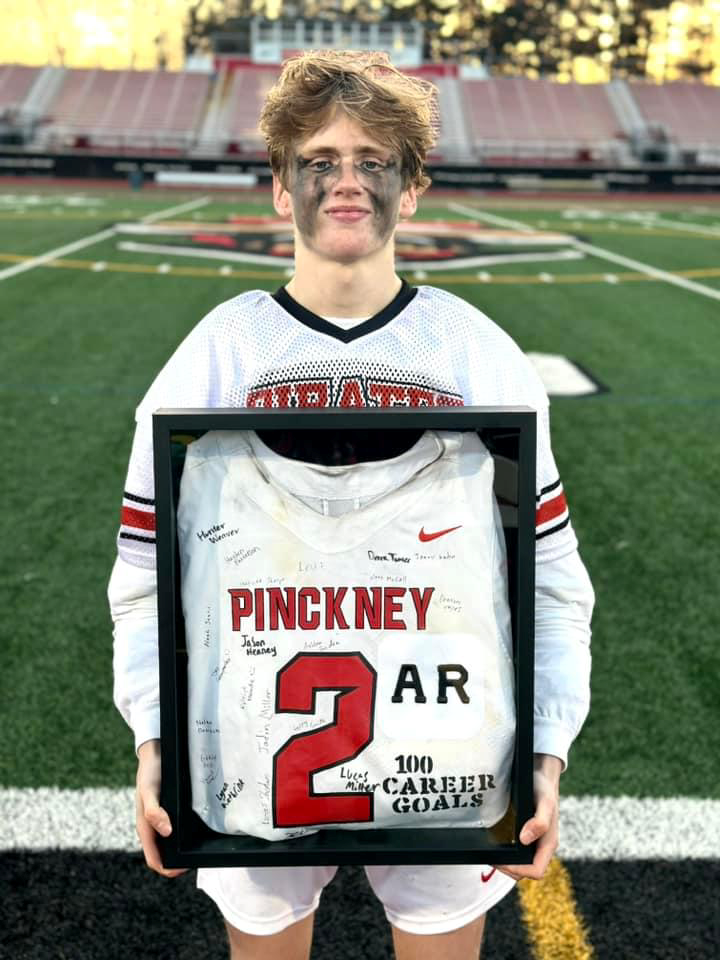 Alex Rau of Pinckney scored his 100th career lacrosse goal during a 17-3 victory over Ypsilanti Lincoln Friday, April 19, 2024.
