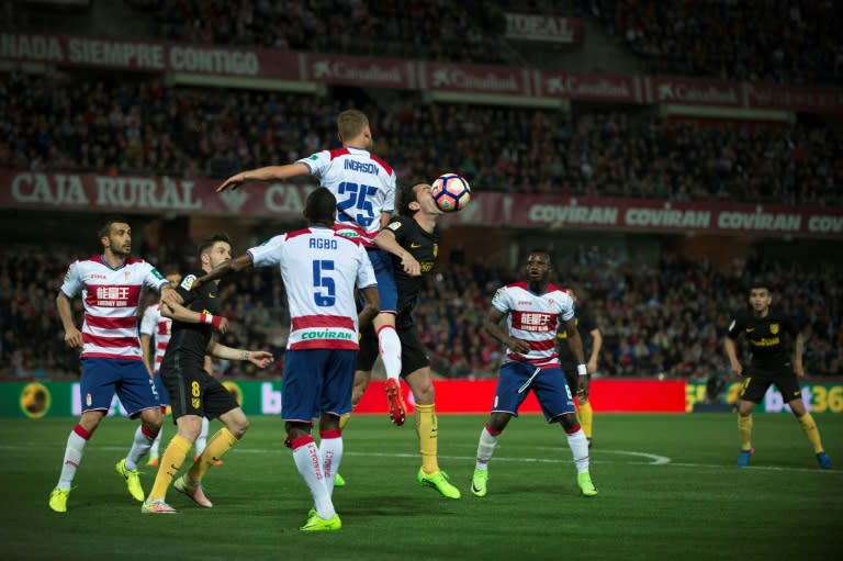 Granada's Sverrir Ingi Ingason vies with Atletico Madrid's Diego Godin (3rdR) during their Spanish league football match in Granada on March 11, 2017