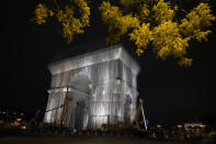 Workers wrap the Arc de Triomphe monument, Wednesday, Sept. 15, 2021 in Paris. The "L'Arc de Triomphe, Wrapped" project by late artist Christo and Jeanne-Claude will be on view from, Sept. 18 to Oct. 3. The famed Paris monument will be wrapped in 25,000 square meters of fabric in silvery blue, and with 3,000 meters of red rope. (AP Photo/Francois Mori)