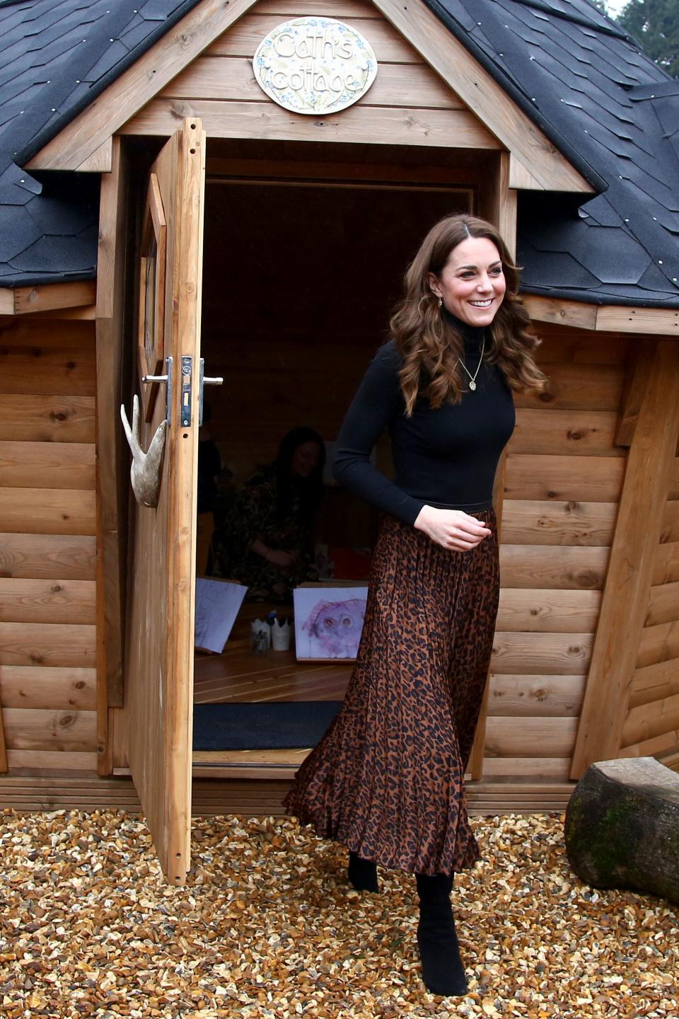 Once inside the centre Kate showed off the leopard print skirt, which she paired with a black jumper. [Photo: Getty]