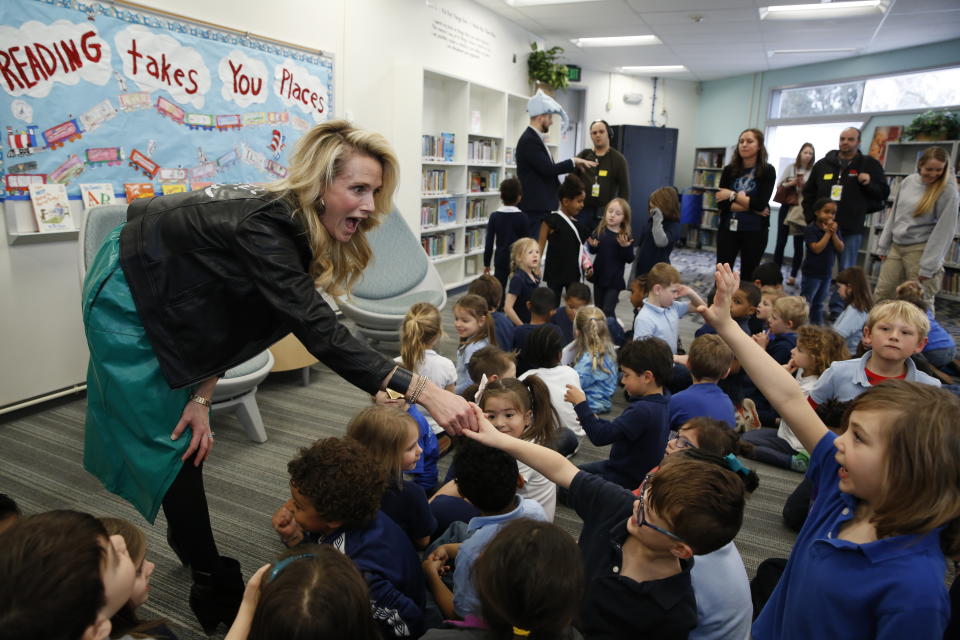 FILE-- IN this March 1, 2019 file photo first partner, Jennifer Siebel Newsom, the wife of Gov. Gavin Newsom, is greeted by kindergarteners at the Washington Elementary School in Sacramento, Calif. Siebel Newsom visited the school, with her husband to celebrate Read Across America Day. Siebel Newsom often attends events with her husband but also works on issues of her own including equal rights for women. (AP Photo/Rich Pedroncelli, File)