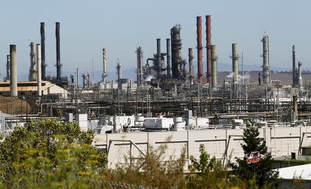 Chevron Corp's refinery, struck by a major fire, is shown still smouldering in Richmond, California, U.S. on August 7, 2012. REUTERS/Robert Galbraith/File Photo