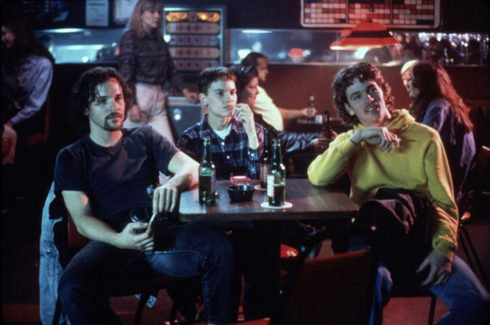 Three young people sitting at a restaurant table