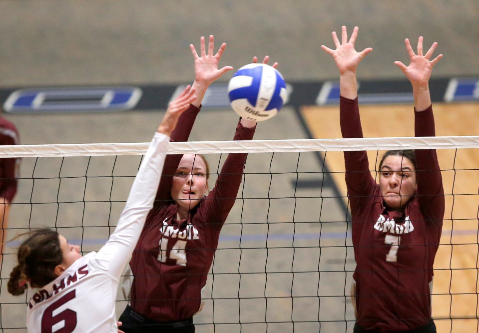 Jenks' Maren Johnson spikes the ball as Edmond Memorial's Kathrin Rowe (14) and Chandler Lawrence (70 defend during the 6A state volleyball championship match between Edmond Memorial and Jenks at Noble High School in Noble, Okla., Saturday, Oct., 22, 2022. 