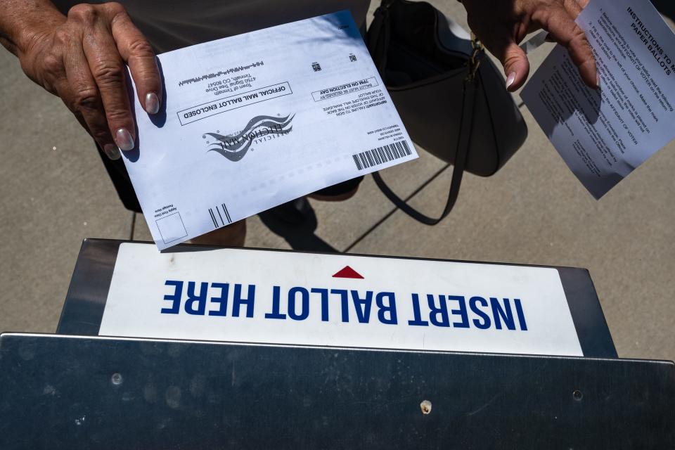 A voter drops off a ballot at Timnath City Hall on June 27. Residents voted in a special election on a measure that would effectively prohibit a Topgolf from being built in the Ladera development.