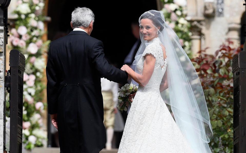 Pippa Middleton arriving at the church with her father Michael Middleton - Credit: AP Photo/Kirsty Wigglesworth, Pool