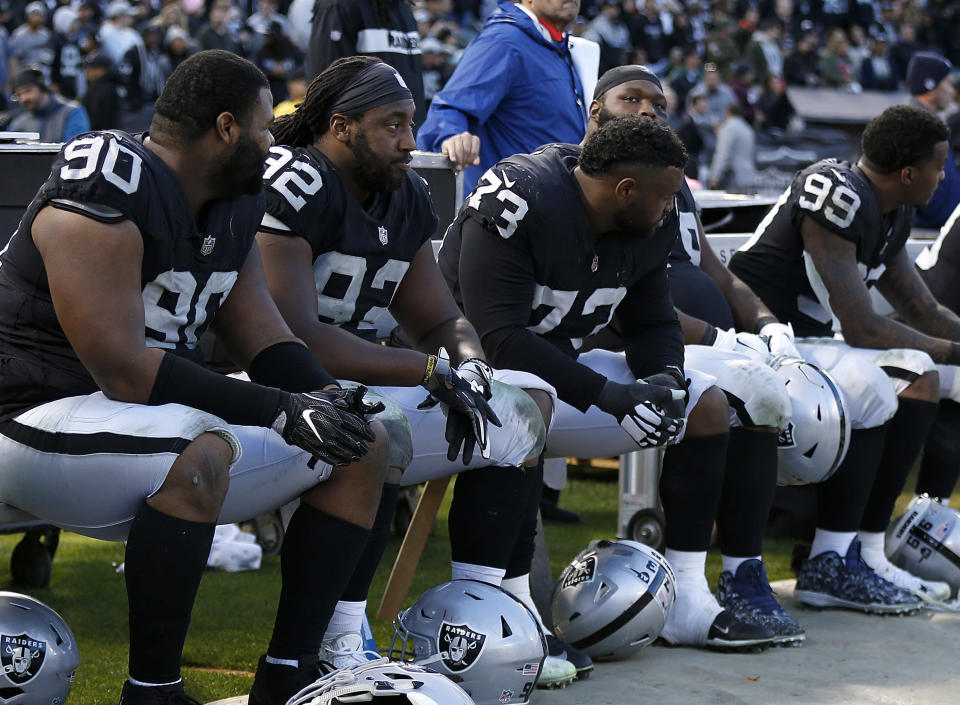 Oakland Raiders players sit on the bench during the second half of an NFL football game against the Kansas City Chiefs in Oakland, Calif., Sunday, Dec. 2, 2018. (AP Photo/D. Ross Cameron)