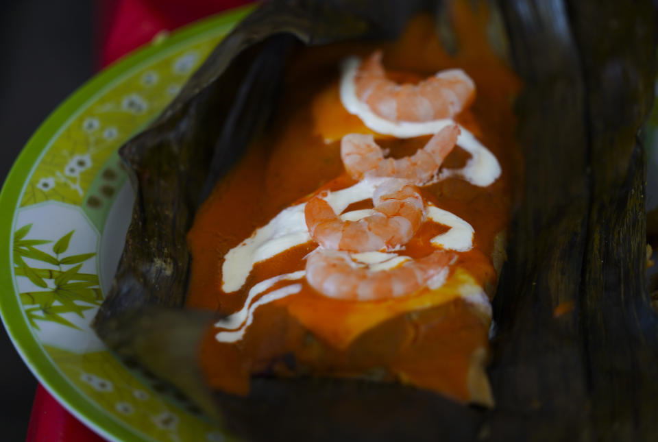 A shrimp tamal is displayed during the tamales fair in the Ixtapalapa neighborhood of Mexico City, Friday, Jan. 27, 2023. From north to south, hundreds of savory and sweet tamal varieties proliferate in Mexico. (AP Photo/Fernando Llano)