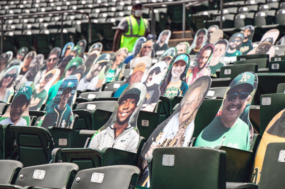 This July 15, 2020, photo provided by the Oakland Athletics baseball team shows fan cutouts in the stands at RingCentral Coliseum in Oakland, Calif., the Athletics home field. The Oakland Athletics offer a wide range of prices, but fans who pay $149 will have cutouts of their likenesses on the first-base side of RingCentral Coliseum plus an autographed photo from outfielder Stephen Piscotty. Proceeds benefit the Piscotty family foundation that’s seeking a cure for ALS, the disease that killed Piscotty’s mother. If a foul ball happens to hit a cutout, the owner receives a baseball signed by Piscotty. (Kyle Skinner/Oakland Athletics via AP)
