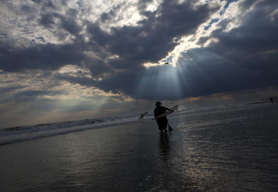 A participant exits the water during the third annual Rockaway Halloween surf competition at Rockaway Beach in the Queens borough of New York