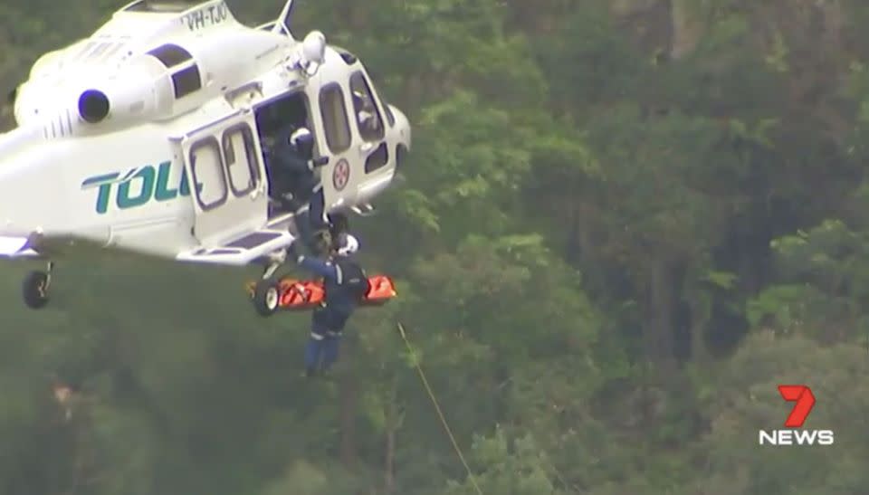 A survivor is winched to a waiting helicopter. Source: 7 News