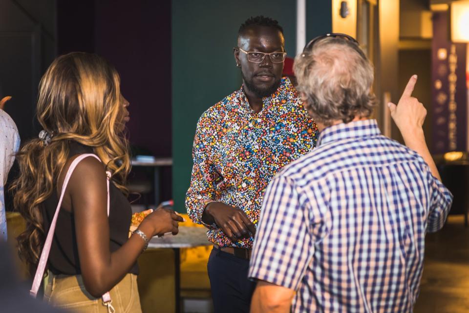 Co-founder Kuol Malou mingles with community members at The HUB's launch party Thursday, July 28, at Swamp Daddy's Cajun Kitchen in Sioux Falls.