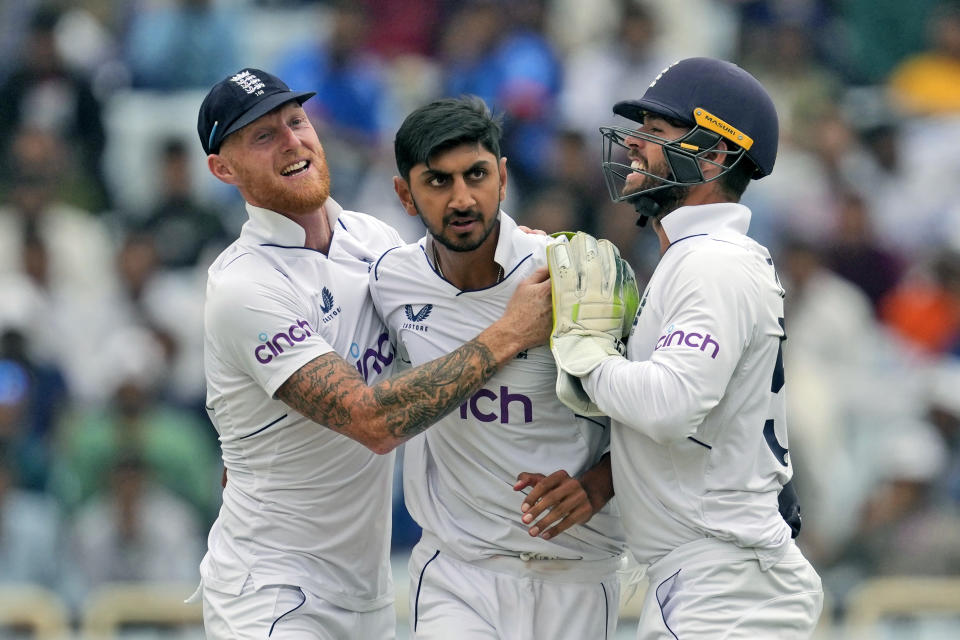 England's Shoaib Bashir, center, is congratulated by captain Ben Stokes, left and teammate Ben Foakes for taking the wicket of India's Rajat Patidar on the second day of the fourth cricket test match between England and India in Ranchi, India, Saturday, Feb. 24, 2024. (AP Photo/Ajit Solanki)