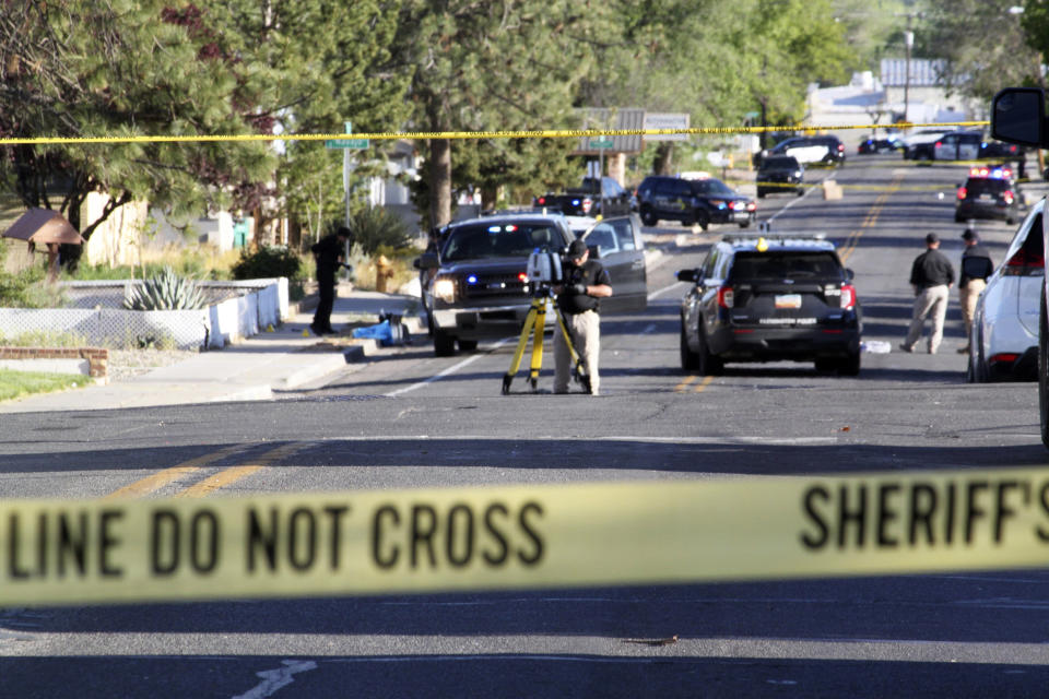 Investigators work along a residential street following a deadly shooting Monday, May 15, 2023, in Farmington, N.M. Authorities said an 18-year-old opened fire in the northwestern New Mexico community, killing multiple people and injuring others, before law enforcement fatally shot the suspect. (Susan Montoya Bryan / AP)