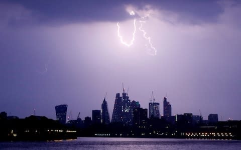 General view as lightning strikes over the City of London - Credit: REUTERS/Tom Jacobs