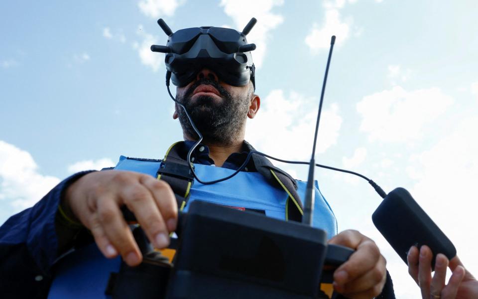 British Secretary of State for Foreign, Commonwealth and Development Affairs James Cleverly operates an unmanned demining vehicle as he visits members of the Halo Trust non-commercial charity organisation for demining - VALENTYN OGIRENKO/REUTERS