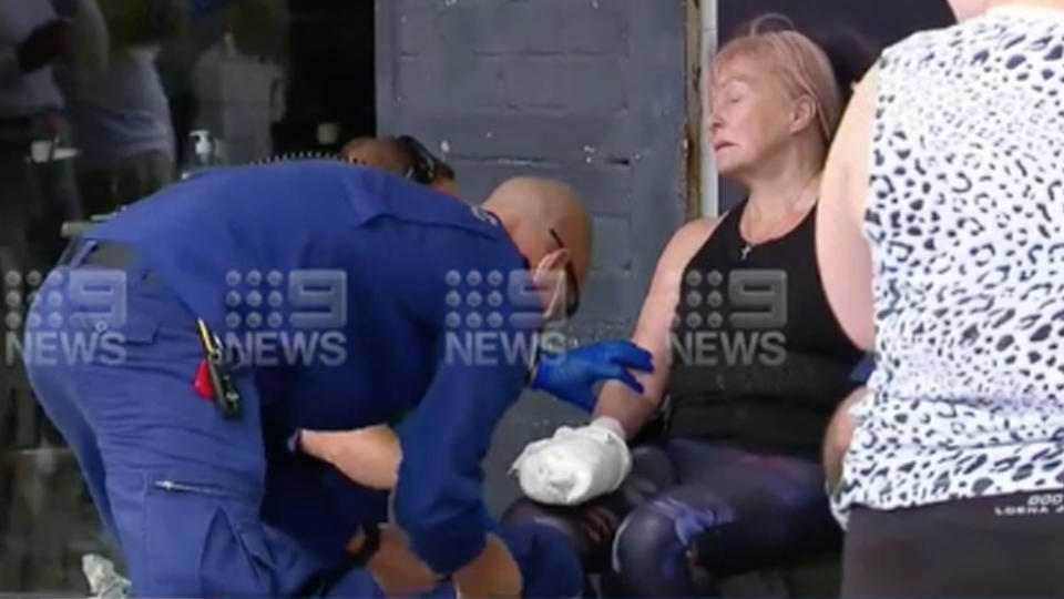 A woman is being treated by paramedics after a dog attack in cronulla 