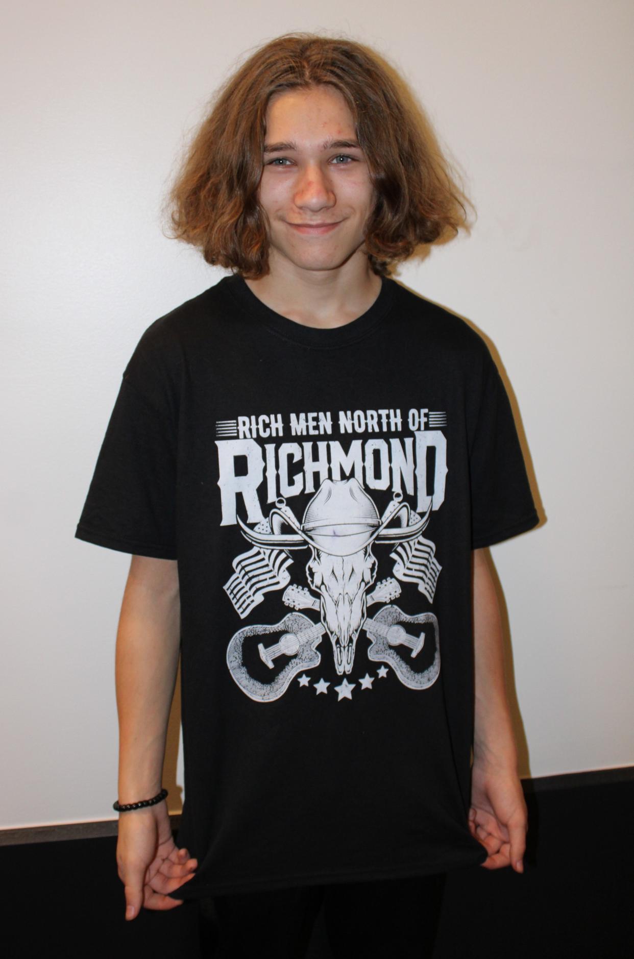 Dylan Hedley, 14, of Amherst County strikes a pose in his Oliver Anthony T-shirt at a concert at Longwood University in Farmville on October 28.