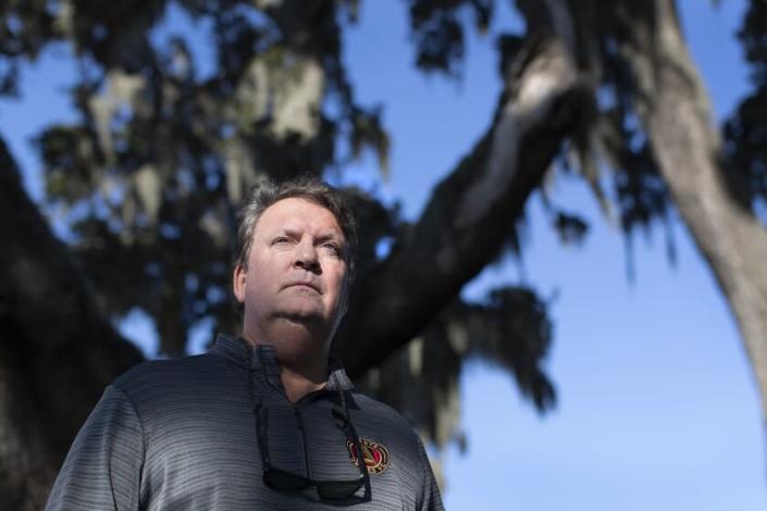 Coastal Carolina University theatre professor Steve Earnest stands under a grove of trees near his home on Saturday, November 13, 2021, in Myrtle Beach, South Carolina. Earnest has been involved in a controversy with minority students on campus after he refused to apologize after minority students&#39; names were listed on a whiteboard in a class. A committee of professors swiftly found the concern to be based on a misunderstanding: the list was an attempt by a visiting artist to help minority students connect with other non-white students on campus. &quot;Sorry but I don&#39;t think it&#39;s a big deal,&quot; Earnest wrote in an email to faculty and students. &quot;I&#39;m just sad people get their feelings hurt so easily.&quot; The controversy has resulted in boycotts of his classes, and he has since been delegated to other duties at the University. (Randall Hill/ For the Los Angeles Times)