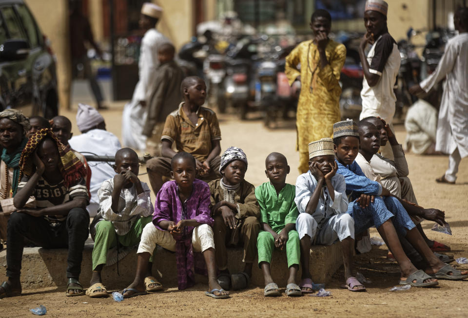 Young Muslim boys wait for traditional Friday prayers to begin at a mosque near to the Emir's palace a day prior to the start of the elections, in Kano, northern Nigeria, Friday, Feb. 15, 2019. Nigeria is due to hold general elections on Saturday, pitting incumbent President Muhammadu Buhari against leading opposition presidential candidate Atiku Abubakar. (AP Photo/Ben Curtis)